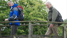 Jim and Derek crossing over a wooden footbridge