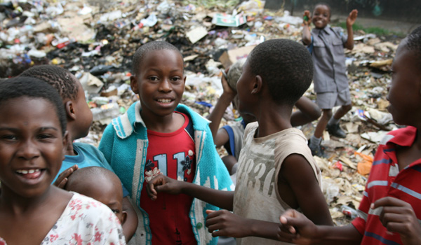 Children playing near a rubbish tip in Harare