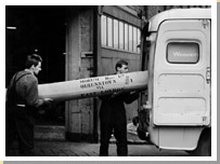 Men loading a Templeton’s carpet into a van on its way to Queens Town.