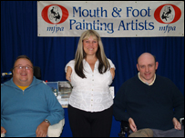 three people in front of MFPA banner