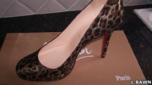 A shoe by Christian Louboutain with distinctive red sole