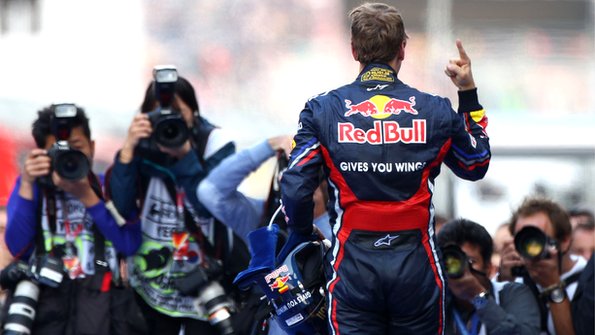 Sebastian Vettel celebrates in front of photographers in Korea