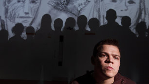 Robert Softley with the silhouettes of the Girl X cast in the background