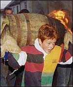 A young child tarbarrelling