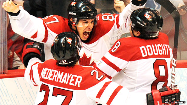 Canadian players celebrate ice hockey gold