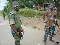 Soldado de paz ao lado de rebelde do Lurd