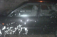 Car hit by a paint-bomb.