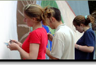 Image of young people painting mural together