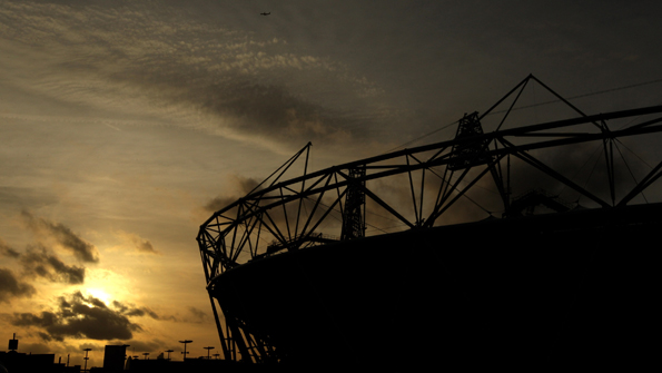 The sun seen behind the Olympic Stadium at London's Olympic Park