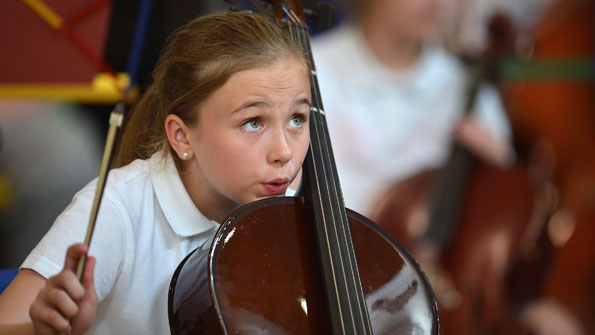 Picture of girl rehearsing for Simon Bolivar Orchestra concert