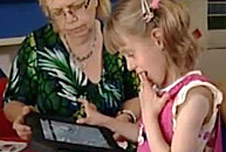 Ruby using the speech application with her teacher