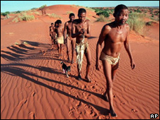 Bushmen walk on the dunes in the Kalahari 