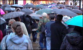 A street scene with lots of umbrellas in