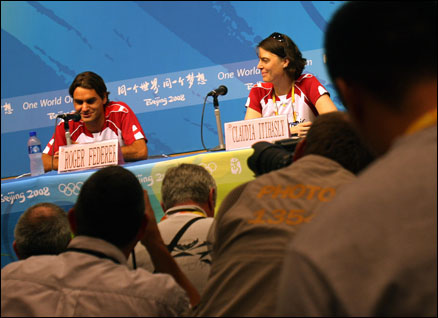 Roger Federer faces a mob of photographers in Beijing