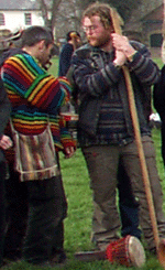 Modern Pagans, some wearing brightly coloured, natural or hand-made clothing and with a ritual staff and drum