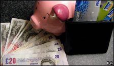Bank notes, a piggy bank and a plastic card.