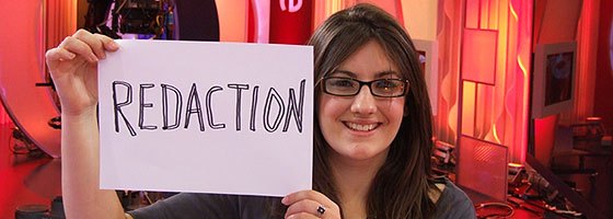 Amy holding the word redaction - on the day she passed her degree