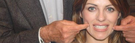 John Cleese shows Elizabeth Hurley how to create a fake smile