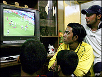 Members of a family in Baghdad watch a World Cup match