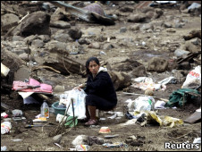 Una mujer trata de recoger sus pertenencias en Amatitilan