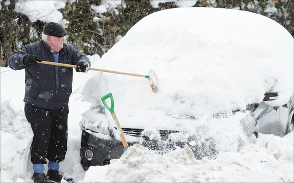 A car being dug out of snow