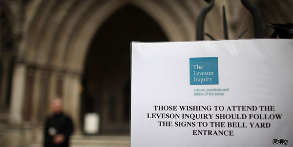A sign direcing people to The Leveson Inquiry is displayed at The Royal Courts of Justice 