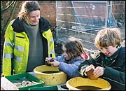 Children sorting through archaeological finds