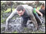 man crawling through mud