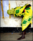 A woman bends over to search for her name on a voting list. 