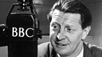 Black and white photograph of Roger Livesey with a BBC microphone, pictured in 1947