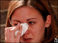 woman trying to dry her eyes