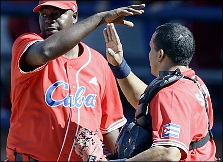 Cuba's reliever Pedro Luis Lazo, left, is congratulated by catcher Eriel Sanhez after their 5-4 win over the United States