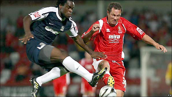 Julian Alsop (right) tangles with Southend United's Jean-Yves Mvoto