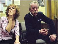 A man and woman smoking