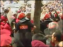 Malaysian police tackling a street protest