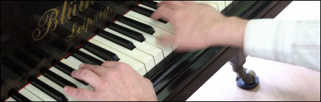 Hands playing a piano