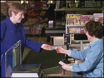 A woman paying for something at a supermarket