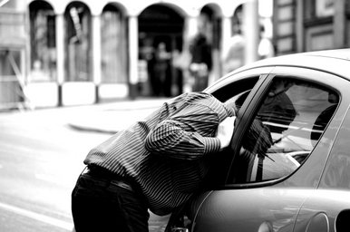 Man looks into the car.