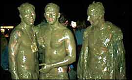 Three very muddy men at Glastonbury 1998