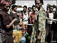 Ethipian women carry jerrycans