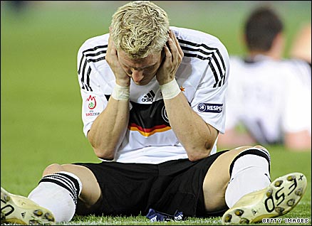 Bastian Schweinsteiger sits dejectedly on the pitch