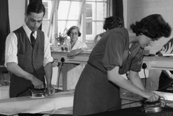 Image: A man and woman ironing