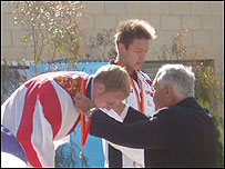 Daniel Halksworth bends down for the gold medal
