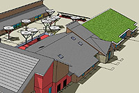 Yr ysgol werdd o'r ochr. Gwelir y canopiau ar y lle chwarau a fydd yn rhoi lloches wrth yr haul a'r glaw.