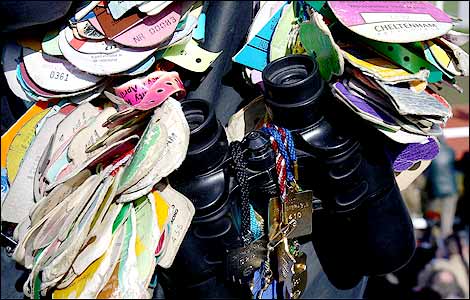 Badges surround a pair binoculars during day two of the Cheltenham Festival 2009 (Getty image)