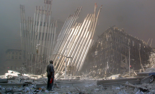 A man, covered in dust looks at the ruins of the World Trade Centre. (Photo: AFP/Getty Images)