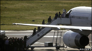 British nationals evacuated from Libya board Astraeus Airlines plane at Malta International Airport, bound for London's Gatwick Airport, 24 Feb 11