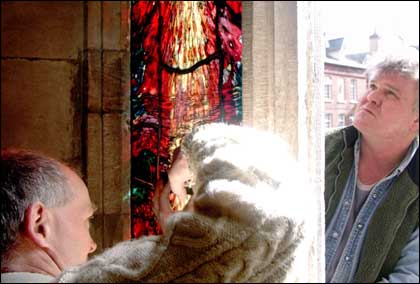 Stained glass window being installed 