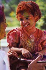 A young girl covered in paint