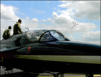 Pilots watch an air display.